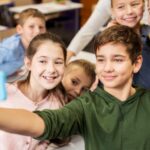 Group of schoolchildren taking selfie